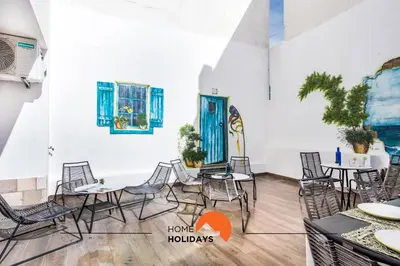a room with chairs and tables in a room at #211 Cerro Lagoa by Home Holidays in Albufeira