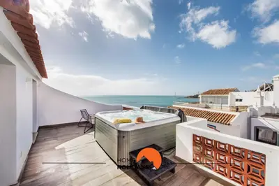 a hot tub on the balcony of a house at #211 Cerro Lagoa by Home Holidays in Albufeira