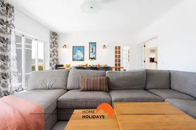a living room with a gray couch and a table at #221 Cerro Grande by Home Holidays in Albufeira