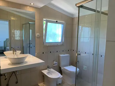 a bathroom with a sink and a toilet and a shower at Villa Sofia in Almancil