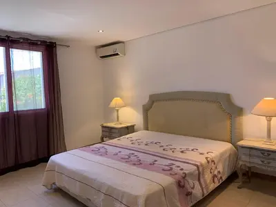 a bedroom with a bed and two lamps and a window at Villa Sofia in Almancil