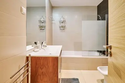 a bathroom with a sink and a tub and a toilet at Apartment Sol de Verão mit Pool in Guia