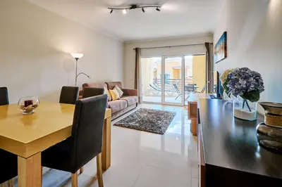 a living room with a table and a dining room at Apartment Sol de Verão mit Pool in Guia