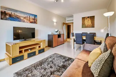 a living room with a couch and a tv at Apartment Sol de Verão mit Pool in Guia
