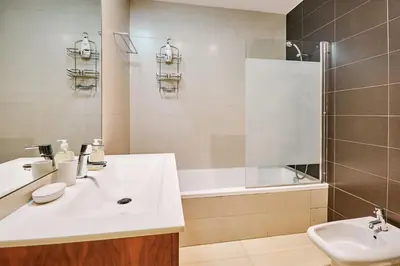 a bathroom with a sink and a shower and a tub at Apartment Sol de Verão mit Pool in Guia