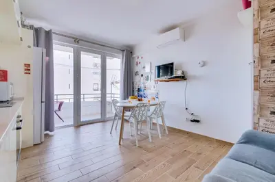 a kitchen and living room with a table and chairs at Noah House, 2 bdr apartment with sea view in Quarteira