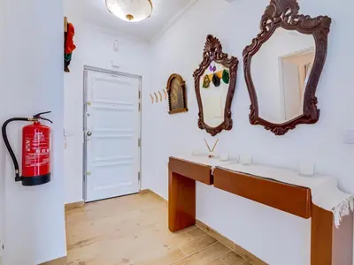 a bathroom with a mirror and a red fire extinguisher at Noah House, 2 bdr apartment with sea view in Quarteira