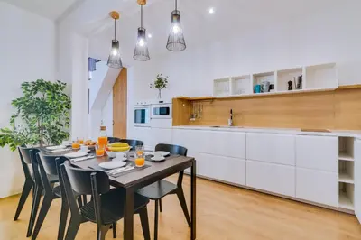 a dining room with a table and chairs in a kitchen at Apartment with Rooftop and work space in Quarteira in Quarteira
