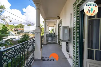 a balcony of a house with a sign that says home holidays at #230 Only Families - Flat A Flor by Home Holidays in Albufeira