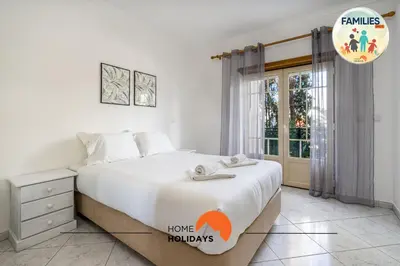 a bedroom with a large bed and a window at #230 Only Families - Flat A Flor by Home Holidays in Albufeira