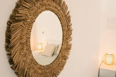 a mirror hanging on a wall in a room at Studio LUMINEUX et CALME à Vilamoura in Quarteira