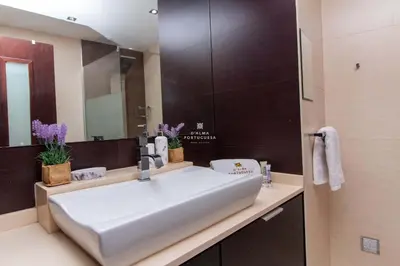 a bathroom with a white sink and a mirror at Brisa Mar-Aveiros Apatment by Dalma Portuguesa in Albufeira