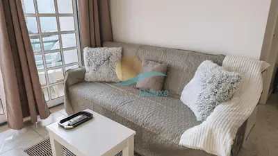 a living room with a couch and a table at Sereia da Oura by Sunny Deluxe in Vale de Pedras