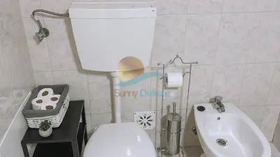 a small bathroom with a white toilet and a sink at Sereia da Oura by Sunny Deluxe in Vale de Pedras