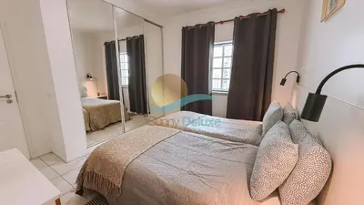 a bedroom with a bed and a mirror at Sereia da Oura by Sunny Deluxe in Vale de Pedras