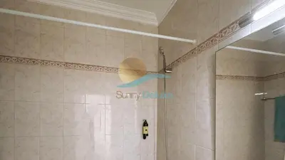 a bathroom with a shower with a sign on the wall at Sereia da Oura by Sunny Deluxe in Vale de Pedras