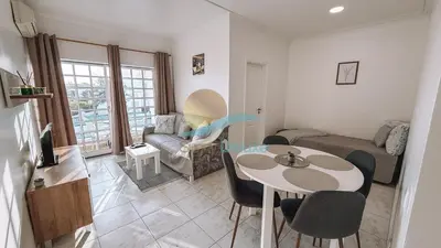 a living room with a table and a couch at Sereia da Oura by Sunny Deluxe in Vale de Pedras