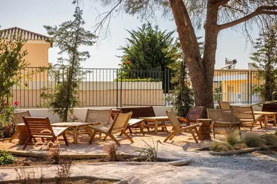 a swimming pool with a chaise lounge chair next to it at Castelo Suites Hotel in Albufeira