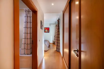a hallway with a door leading to a bedroom at Vilamouratenis Monet by SAPvillas in Vilamoura