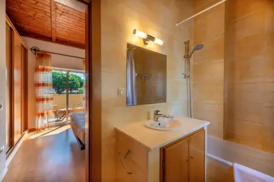 a bathroom with a sink and a mirror at Vilamouratenis Monet by SAPvillas in Vilamoura