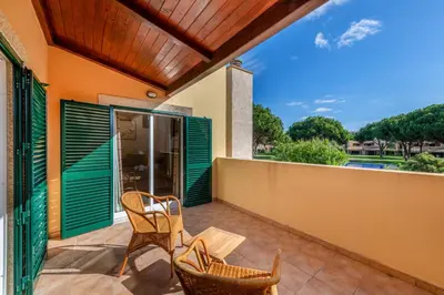 a patio with two chairs and a table at Vilamouratenis Monet by SAPvillas in Vilamoura