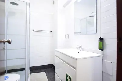 a white bathroom with a sink and a shower at Aqua Plaza 2 Bedr swimming pool 5 min to the beach in Olhos de Água