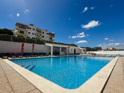 a large swimming pool in front of a building at Aqua Plaza 2 Bedr swimming pool 5 min to the beach in Olhos de Água