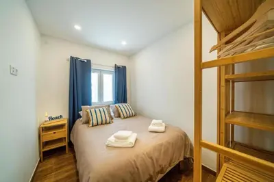 a bedroom with a bed with two towels on it at Oldtown Starfish Beach House 2 min to the beach Wifi in Albufeira