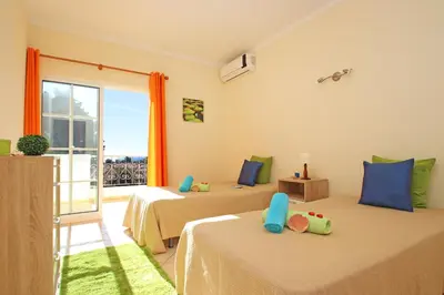 two beds in a room with a balcony at Villa Bella Vista by Algarve Vacation in Albufeira