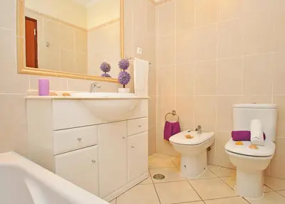 a bathroom with a sink and a toilet and a mirror at Villa Bella Vista by Algarve Vacation in Albufeira