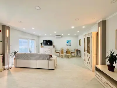 a bedroom with a bed and a dining room at BrisaMarVilas Sea view, 5 min Walk to Town & Beach in Albufeira