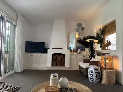 a living room with a fireplace and a tv at Vilamouratenis White by SAPvillas in Vilamoura