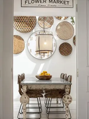 a dining room with a table and plates on the wall at Vilamouratenis White by SAPvillas in Vilamoura