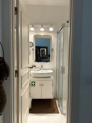 a bathroom with a sink and a mirror at Vilamouratenis White by SAPvillas in Vilamoura