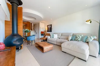 a living room with a couch and a fireplace at Apartment Atlantic - Vale de Lobo in Almancil