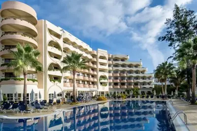 a hotel with a swimming pool in front of a building at Self-Catering Studios & Apartments at Hotel Cerro Alagoa in Albufeira