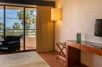 a room with a desk with a television and a chair at Self-Catering Studios & Apartments at Hotel Cerro Alagoa in Albufeira