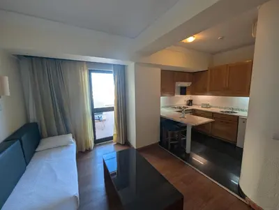 a living room with a couch and a kitchen at Self-Catering Studios & Apartments at Hotel Cerro Alagoa in Albufeira