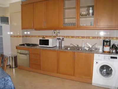 a kitchen with a sink and a microwave at Appartement Quarteira in Quarteira