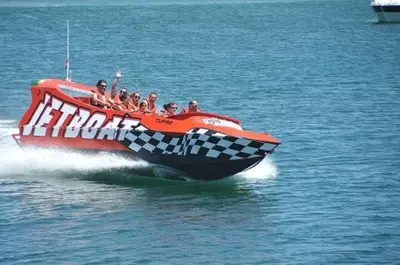 a group of people riding a boat in the water at Appartement Quarteira in Quarteira