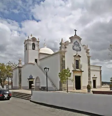 a church with a car parked in front of it at Appartement Quarteira in Quarteira