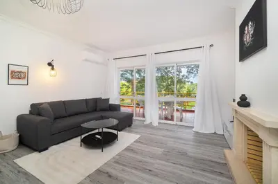 a living room with a couch and a fireplace at Vilamoura Family Escape in Quarteira
