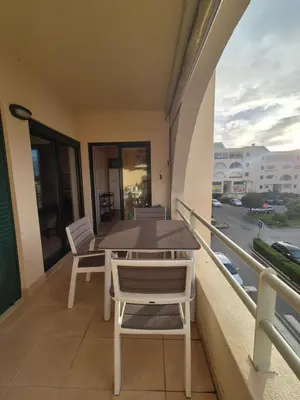 a table and chairs on a balcony with a view of a street at Casa Algarve in Albufeira
