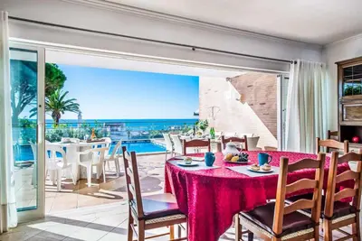 a dining room with a table and a view of the ocean at Atlantic Sul in Albufeira