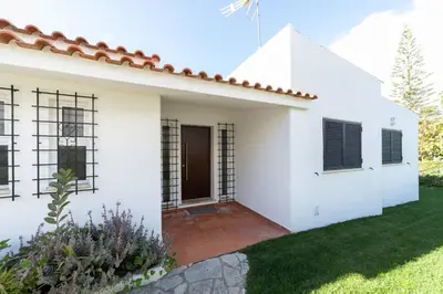 a white house with a red roof at Villa Uno by HelloVacations in Loulé