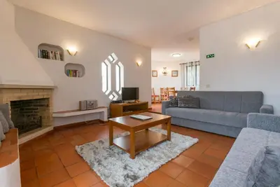 a living room with a couch and a table at Villa Praia in Albufeira