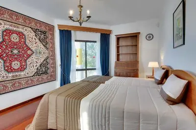 a bedroom with a large bed and a window at Villa Mar in Albufeira