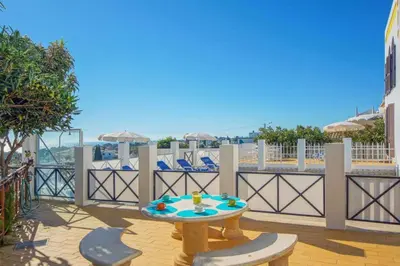 a patio with a table and chairs on a balcony at Villa Mar in Albufeira