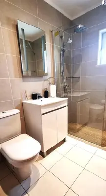 a bathroom with a toilet and a sink and a shower at T2 Vilamoura - com piscina e campo tenis in Vilamoura