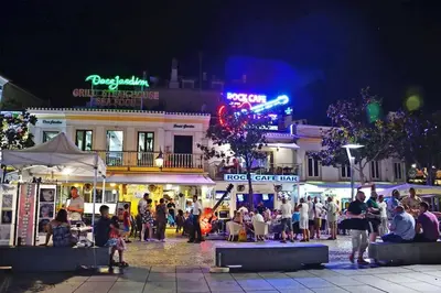 a crowd of people standing around a street at night at Albufeira Central Studio w swim pool and Seaview in Albufeira